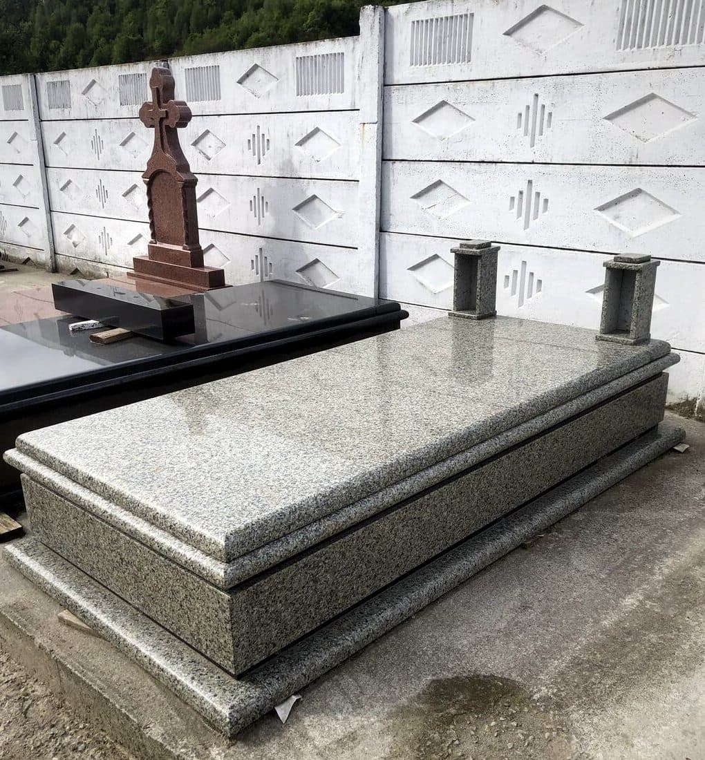 Cadru funerar simplu din granit gri, expus în atelierul Mogut.
